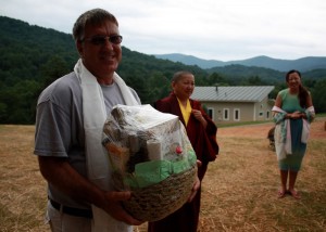 On behalf of Lotus Garden, HE Jetsün Khandro Rinpoche and Jetsün Dechen Paldrön present a gift basket to Mark Good, builder of Tashi Chö Dzong.