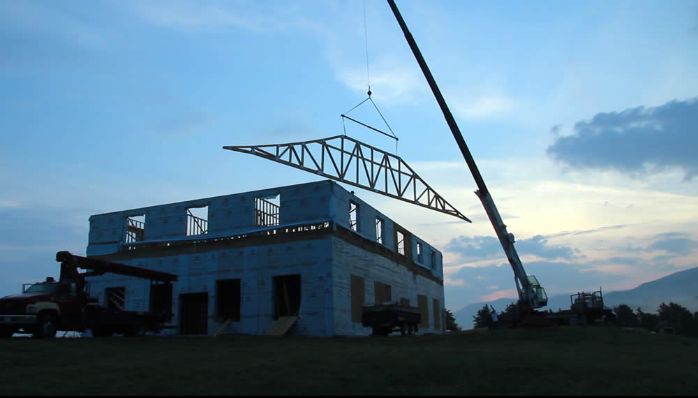 Raising the first roof truss of the temple.