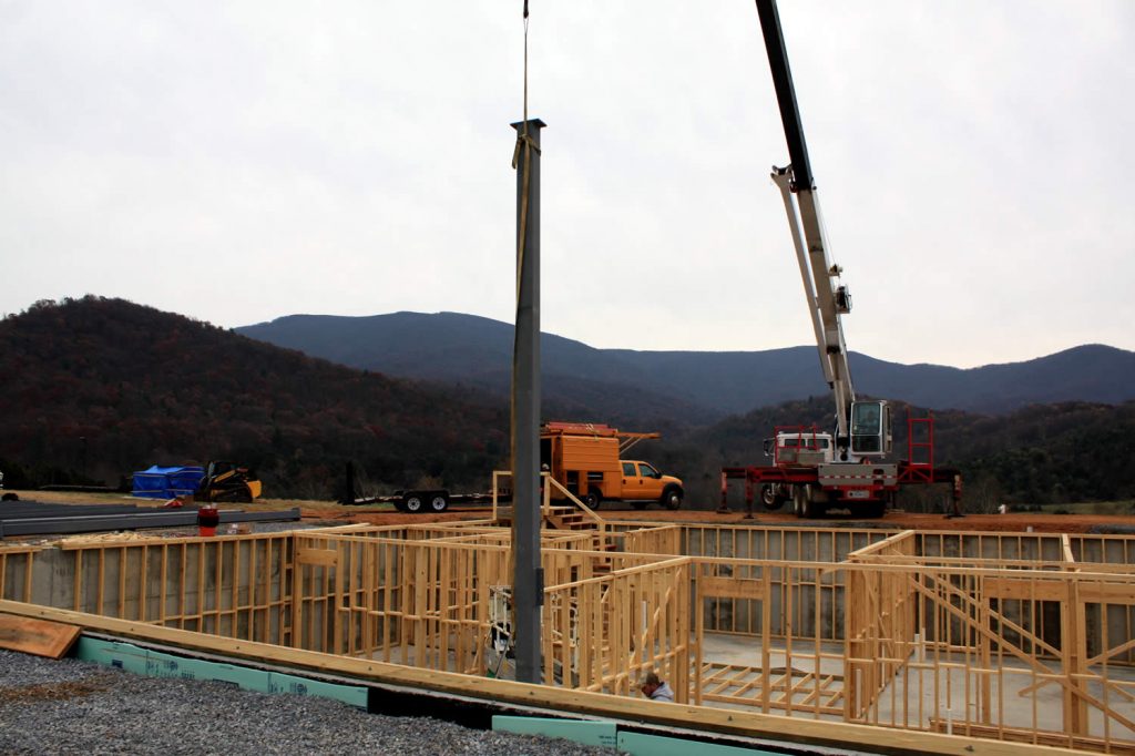 NOVEMBER 28--Lowering a vertical beam into position.