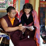 Ven. Acarya Namdrol Gyatso works with a student during Tibetan language class