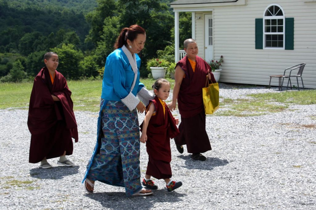 Dungse Rinpoche and his mother, Jetsun Dechen Paldron, arrive at the main shrine room